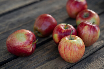 Ripe red apples on wooden background .