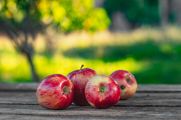 Ripe red apples on wooden background .