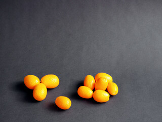 Fototapeta na wymiar Kumquat or cumquat on black background