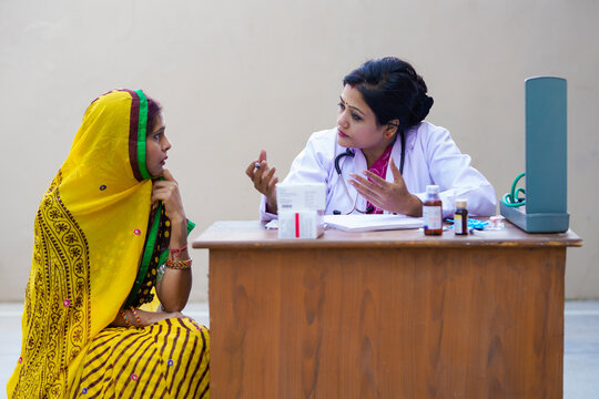 Young Indian Woman Doctor Advise To Rural Woman At Clinic