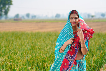 Indian rural woman standing at agriculture field