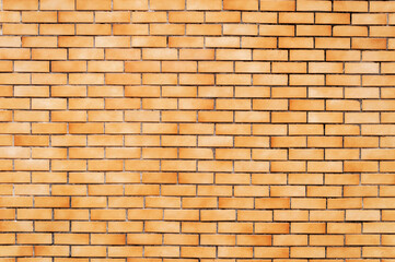 Wall of small orange bricks. Horizontal image. Space for advertising.