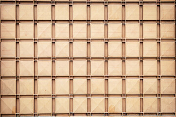 Squares gate, beige metal. Horizontal image. Space for advertising.