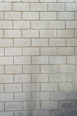 Wall made with gray bricks. Vertical image. Space for advertising.