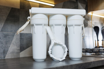 Water filtration system with replaceable cartridges. A system in an apartment with three tanks for...