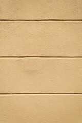 Fototapeta premium Beige masonry wall with grooves. Vertical. Advertising space.