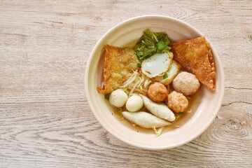 boiled Hakka meatball made fish and shrimp with bean sprout and lettuce in spicy soup on bowl