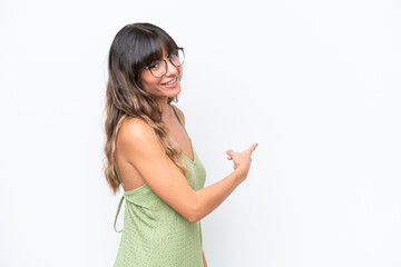 Young caucasian woman isolated on white background pointing back