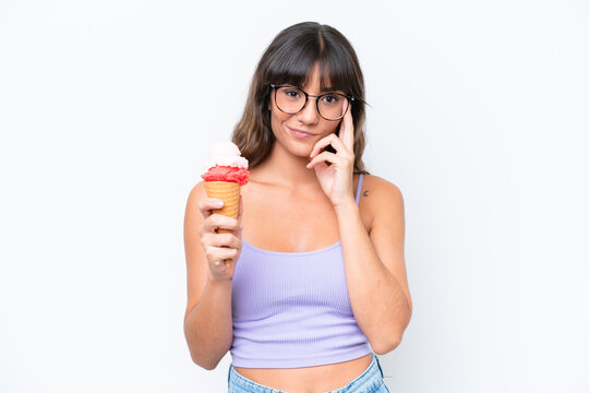 Young caucasian woman with a cornet ice cream over isolated white background thinking an idea