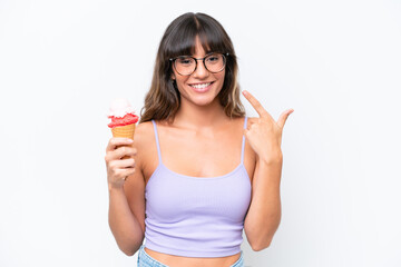 Young caucasian woman with a cornet ice cream over isolated white background giving a thumbs up gesture