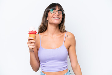 Young caucasian woman with a cornet ice cream over isolated white background laughing