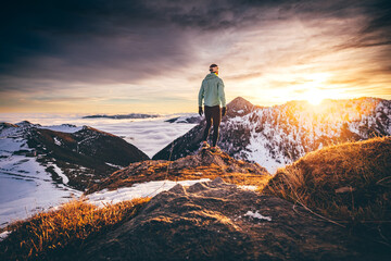 Man trail running in winter on a snowy mountain