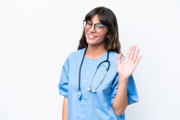 Young caucasian nurse woman isolated on white background saluting with hand with happy expression © luismolinero