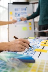 Creative digital development agency. developer team brainstorming on their project with laptop, smartphone and digital tablet.