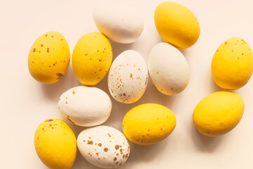 Colorful chocolate Easter eggs on white background with copy space