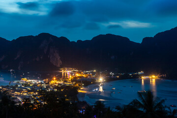 View from above.  View over Ko Phi Phi Don, Thailand from the viewpoint above the town.  The mountains are in silhouette as night falls and the lights are coming on.