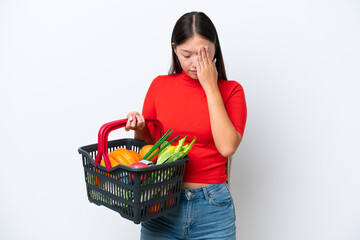 Fototapeta na wymiar Young Asian woman holding a shopping basket full of food isolated on white background with tired and sick expression