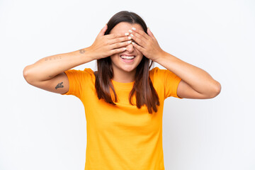 Young caucasian woman isolated on white background covering eyes by hands and smiling