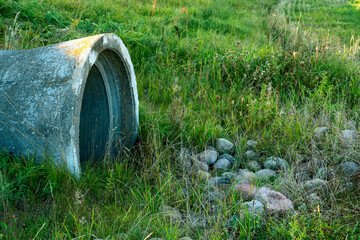 A large concrete pipe for diverting the river under the highway. Leaky dirty water from large concrete pipes. Dirty sewage from the pipe, environmental pollution. Environmental problem