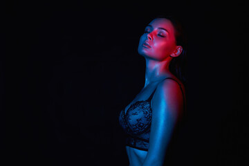 young woman in Underwear. Beautiful sexy Girl in color lights