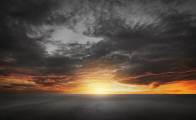Dark Dramatic Sky Horizon Epic Sunset Clouds Landscape with Black Concrete Floor - 561028906