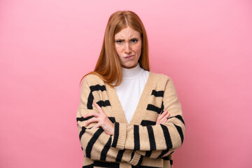 Young redhead woman isolated on pink background with unhappy expression