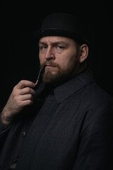 stylish man in retro outfit suit hat smoking wooden pipe sherlock holmes look cosplay england gentleman fashionable confident gangster Guy Ritchie Charlie Hunnam style