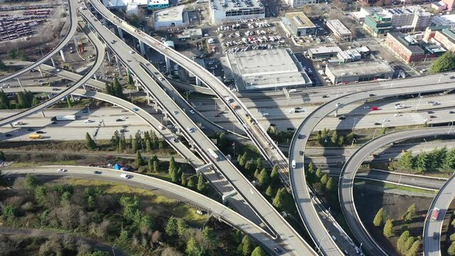 Steady aerial video view of Highway 5 Interchange, located south of Seattle Downtown near the Stadion,  with lots of Car and Truck traffic driving in all directions  - video footage