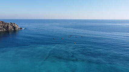 Fototapeta na wymiar Several kayakers in the mediterranean from a drone