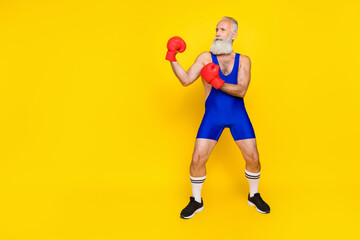 Full length photo old age pensioner wear blue sportswear red gloves battle against abstract opponent empty space funny isolated on yellow color background