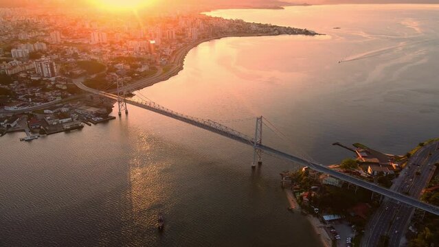 City and Hercilio luz bridge with warm sunset in Florianopolis, Brazil. Drone view