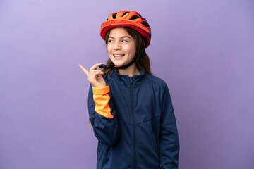 Little caucasian girl isolated on purple background intending to realizes the solution while lifting a finger up