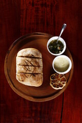 Rustic baked bread with condiments and head of garlic