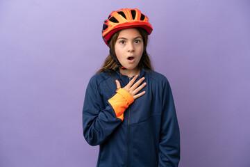 Little caucasian girl isolated on purple background surprised and shocked while looking right