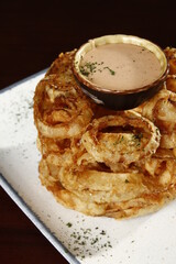 Onion rings tower with dip on top