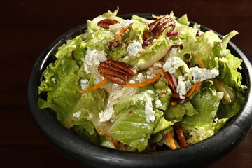 Healthy salad with greens, pecan nuts, bleu cheese
