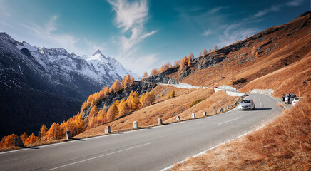 Awesome alpine highland in sunny day. Colorful spring scene. Summer view of Asphalt road...