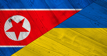 Background with flag of North Korea and Ukraine on wooden split plank. 3d illustration