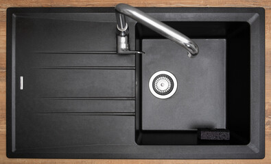 New clean granite kitchen sink black, strainer, holder for kitchen sponge. After. Drops water....