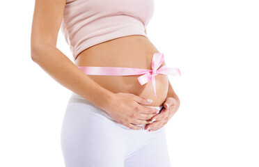Pregnant woman, pink ribbon and stomach on studio background of maternity health and wellness. Belly, pregnancy and bow of baby shower, girl announcement and gift of life, fertility and future mother
