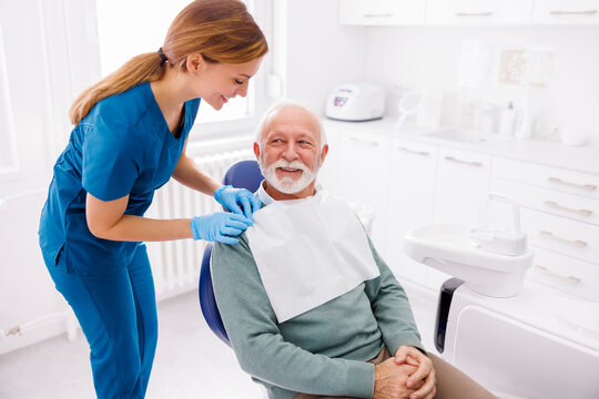 Senior man sitting at dental chair waiting for dentist checkup
