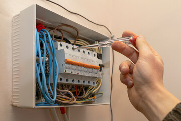 Electrical Switchboard with Automats and Wires. Electrician testing the Electrical Shield Panel....