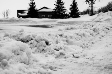 Snowbank at the end of a driveway left after city snowplows cleared a street.