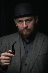 stylish man in retro outfit suit hat smoking wooden pipe sherlock holmes look cosplay england gentleman fashionable confident gangster Guy Ritchie Charlie Hunnam style