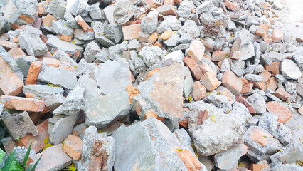 Close up of pile of broken red bricks, fragments of tiles and concrete
