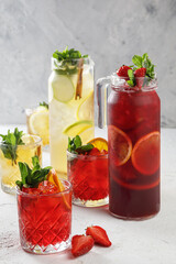 Freshly summer drinks - lemonades isolated on white concrete background