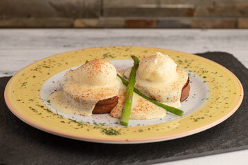 Benedict eggs in a yellow plate