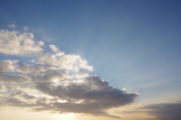 Naklejka na ściany i meble Sun peaking through clouds