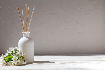 Aromatic reed diffuser and flowers - obrazy, fototapety, plakaty