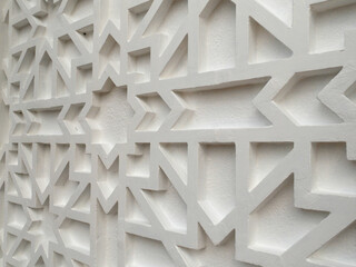 JOHOR, MALAYSIA -AUGUST 2, 2022: Islamic geometry pattern made from ground fiber reinforcement concrete used as building facade wall decoration. Permanently installed and painted.